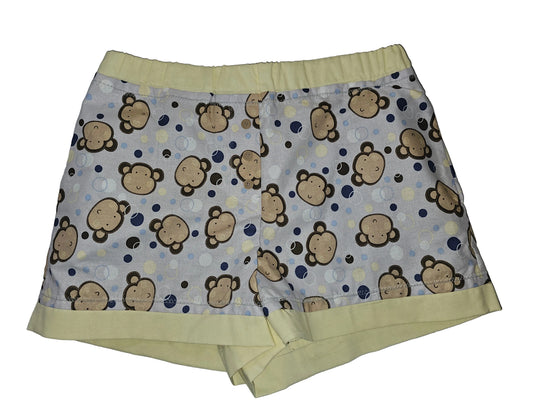 Women's soft cotton lounge boxer with a soft yellow waist and leg bands, detail front buttons, dark blue, light blue, black, and soft yellow circles and bubble though out the patterned with a cartoon happy monkey as the main design - size small