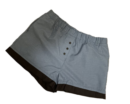 Women’s loungewear boxers in Blue Steel Lounge style, featuring a soft steel-blue body, black contrast hem, three-button front detail, deep side pockets, and a comfortable elastic waistband for a relaxed cozy fit.