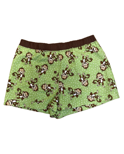 Green women’s loungewear boxers in ‘Cheeky Monkey Lounge’ print, featuring playful brown monkeys on a soft green background, brown elastic waistband, matching brown trims, and deep side pockets — handmade and cozy
