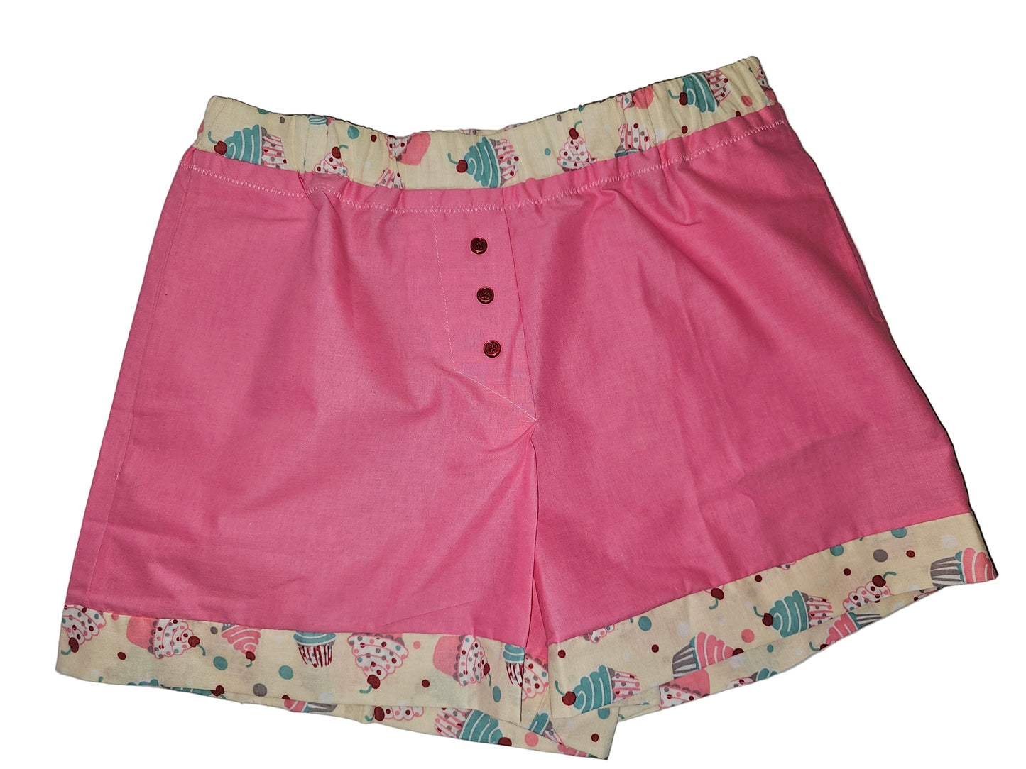 Medium handmade women’s boxers in solid pink with cupcake-print trim, breathable cotton design with deep side pockets — cute, comfy, and perfect for lounging.