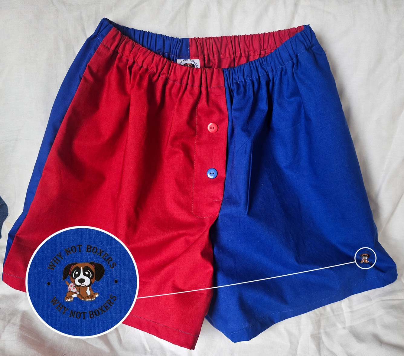 Red and royal blue Medium handmade women’s boxer shorts featuring a split-color design, elastic waistband, contrasting button detail, and custom “Why Not Boxers” puppy logo. Comfortable small-batch loungewear shorts designed for cozy everyday wear and sleepwear.
