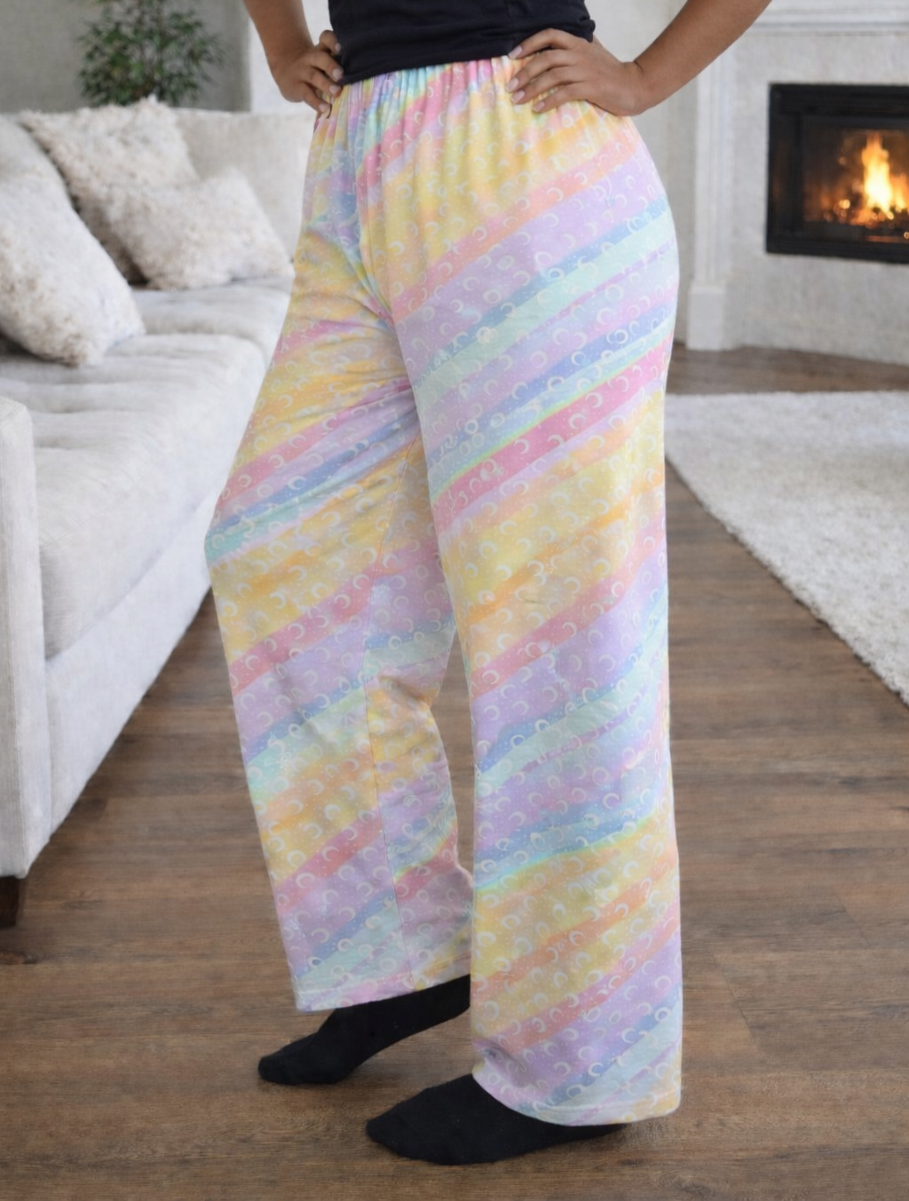 Women’s size large rainbow pastel pajama pants with crescent moon pattern, loose-fit lounge pants with elastic waistband for sleepwear and cozy home wear.