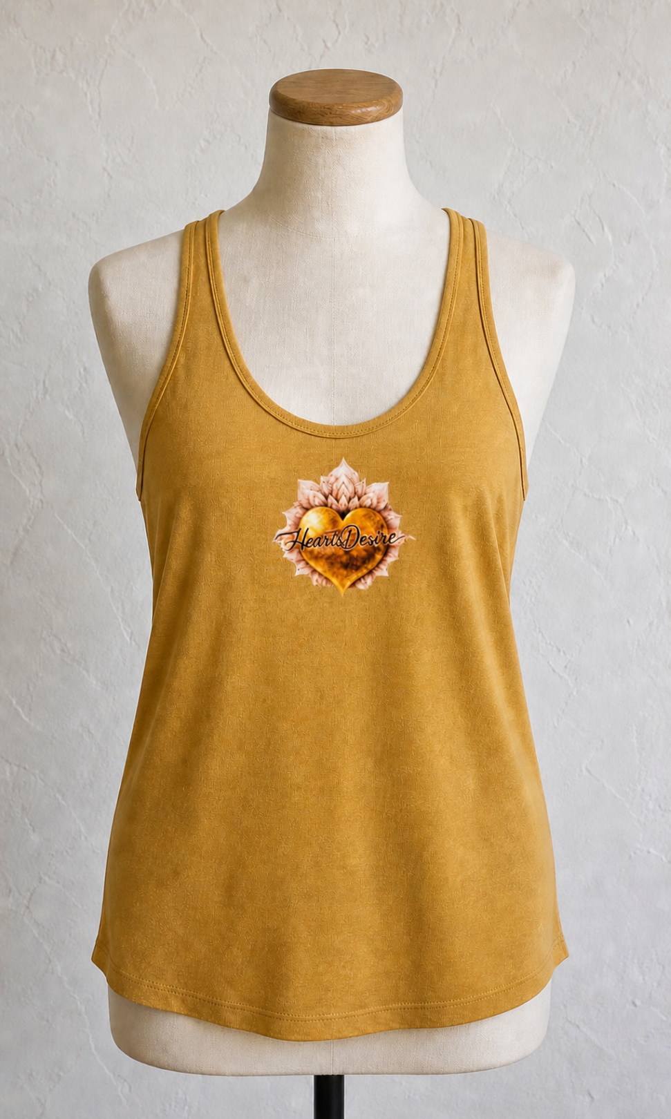 Women’s (Small) loose-fit racerback tank top in mustard gold with Heart’s Desire heart logo graphic
