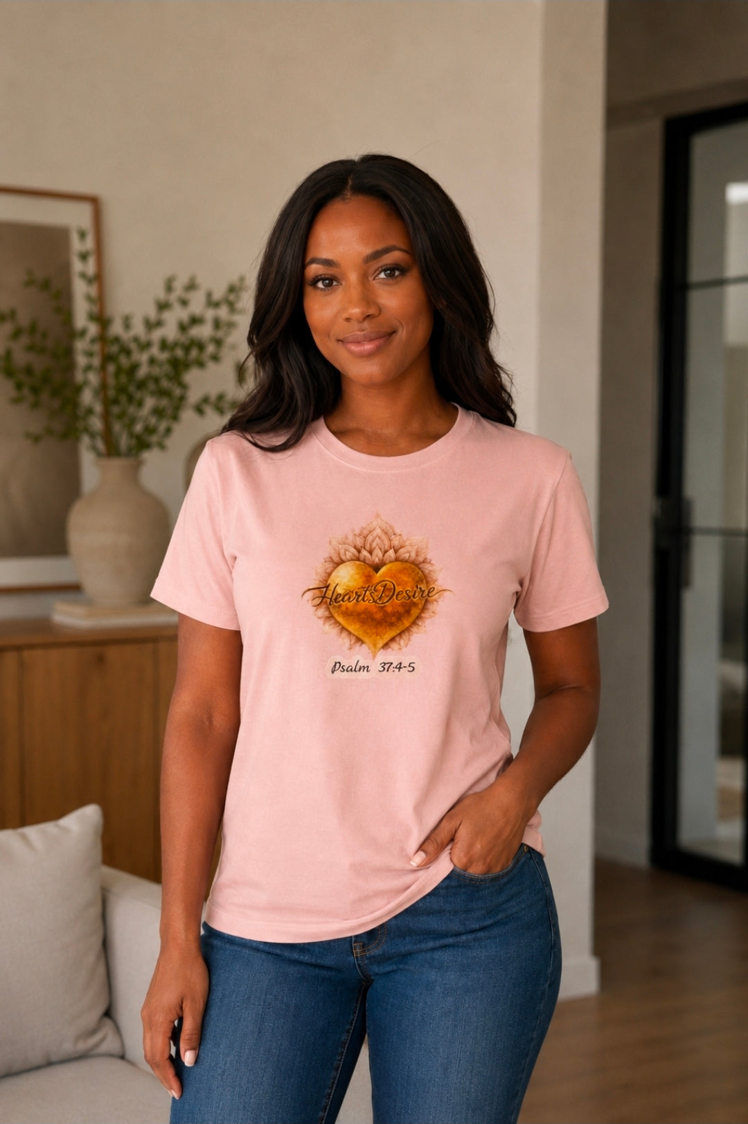 Women’s blush pink XL unisex graphic tee with Heart’s Desire logo and Psalm 37:4-5 artwork on model.