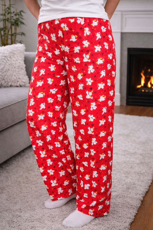 Women’s size large red pajama pants with playful dog and paw print pattern, relaxed fit, soft fabric, and full-length draped legs for comfortable loungewear